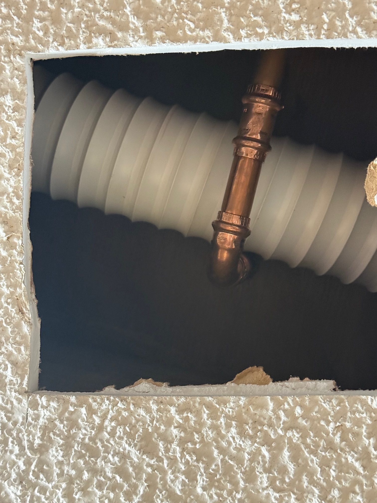 Cut hole in kitchen ceiling and replace leaking pipe