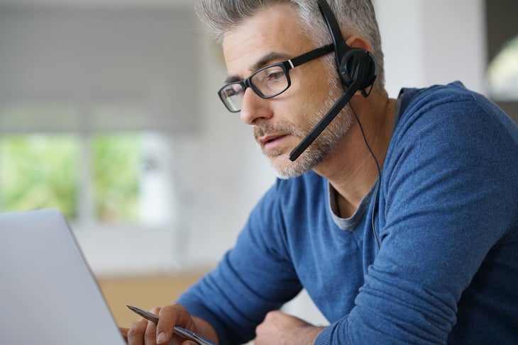 Man working from home using headset.