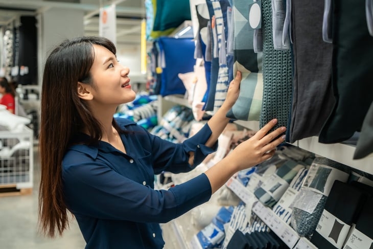 Woman shopping for pillows at a store